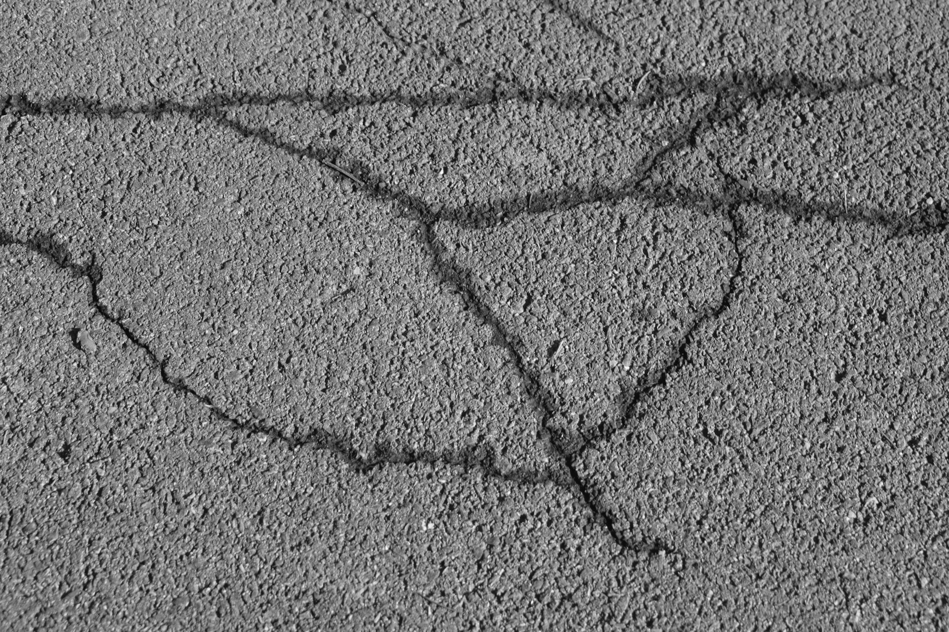 a black and white photo of a heart drawn in the sand